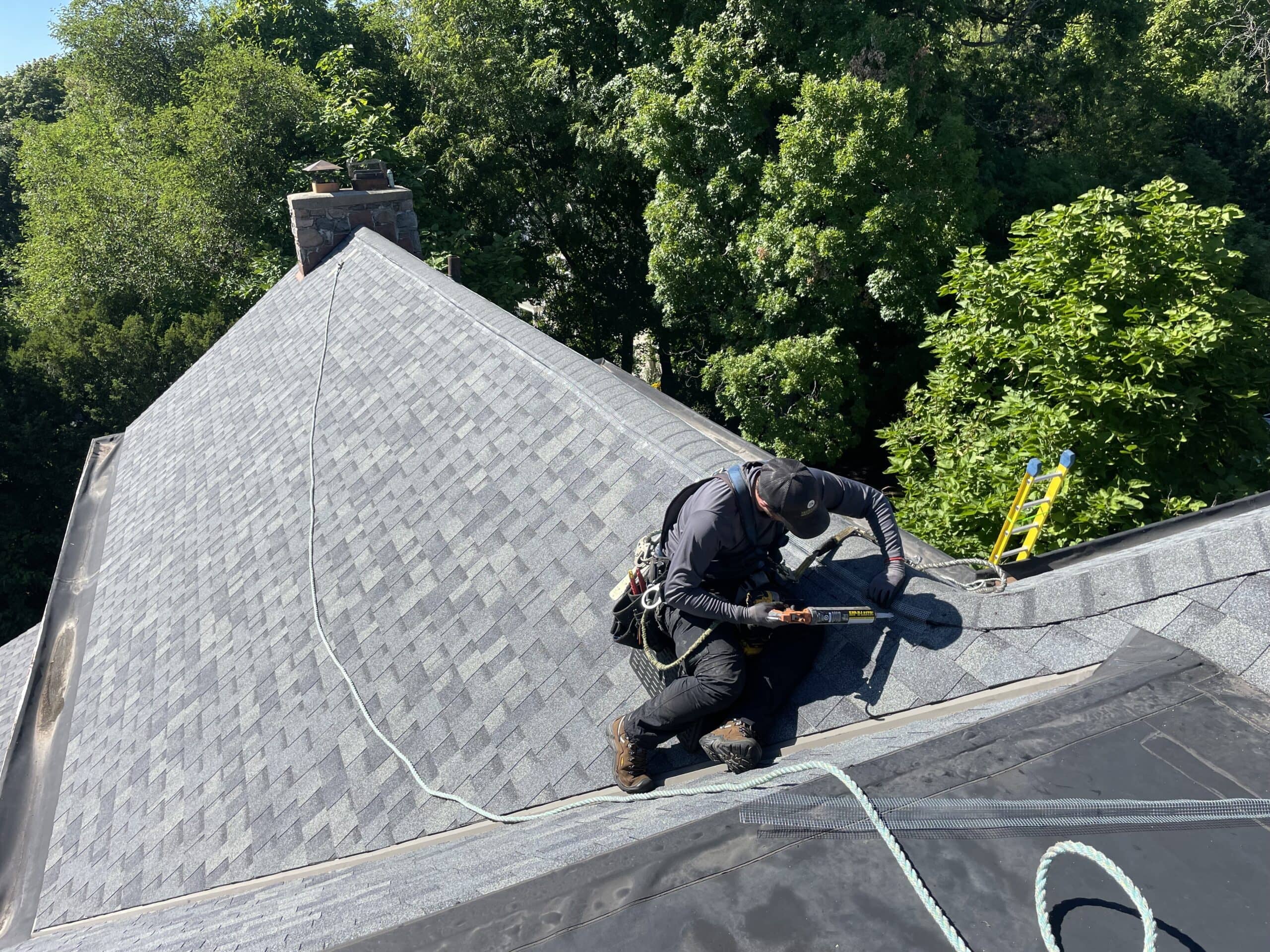 technician working on roof exclusion screening animal damage Milwaukee skedaddle humane wildlife control September 2023